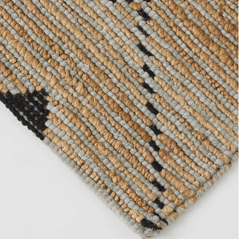 A close up of the Denali wool and jute rug with natural brown and black colours.