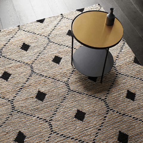 The Denali rug with a round coffee table sitting on top of it.