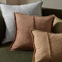 Textured pillows in brown and gray on a sofa