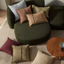 Green sofa with colorful cushions in a living room setting