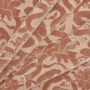Patterned fabric with animal design in shades of soft pinks.