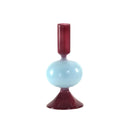 Candle holder with a gradient design from red to blue on a white background