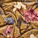 Floral patterned fabric with pink flowers and blue birds on a bronze beige background