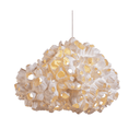 A modern pendant light with a textured, organic cloud-like shade made of layered, ruffled off-white material, suspended by a thin silver cord against a solid white background.