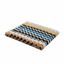 Folded bath towel with a colorful zigzag pattern on a white background