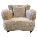 Beige sheepskin armchair with a pillow on a white background