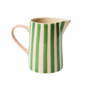 Ceramic pitcher with green and white stripes on a white background