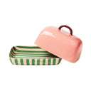 Pink and green striped butter dish on a white background