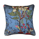 Decorative blue pillow with floral and insect pattern on a white background
