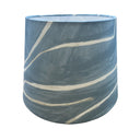 Blue cylindrical container crafted from Graffito fabric with white paint on a white background