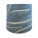 Blue cylindrical container crafted from Graffito fabric with white paint on a white background