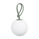 White spherical lamp with a green base and strap on a white background