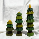 Three layered candle tree decorations on a white background