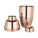 Copper cocktail shaker set on a white background