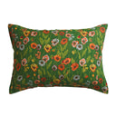 Floral-patterned pillow with orange, yellow, and white blooms on a green background