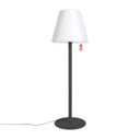 Floor lamp with white shade and black base on a white background
