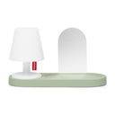 White lamp with a green wall mount base on a white background