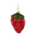 Decorative strawberry ornament with red gemstones on a white background