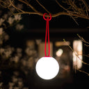White spherical light with red sling