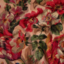 Close-up of a floral fabric with red, pink, and green flowers on a beige background.