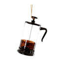 A clear glass French press coffee maker ornament with a black metal lid, handle, and plunger, filled with dark coffee, suspended by a gold hanging string against a plain white background.