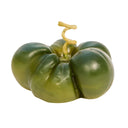 Green tomato candle with a white background