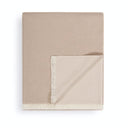 A folded beige throw blanket with cream-colored fringe on a clean white background.