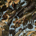 Close-up of a floral fabric pattern with dark and light brown flowers on a blue background
