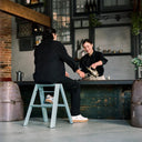 Person sitting on the Lucano Dusty Mint 2 Step Stool