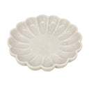 White marble dish with scalloped edge on a white background