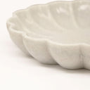 Close-up of a textured marble bowl on a white background