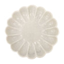 White marble plate with a textured, flower-like design on a white background