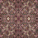 Close-up of a patterned rug with intricate design on a pinkish-purple background