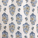 Patterned fabric with blue and beige floral design on a white background