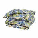 Folded blue and green floral patterned comforter on a white background