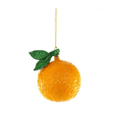A glittery orange Christmas ornament shaped like a textured orange with a green glittery stem and leaves, hanging from a gold string against a white background.
