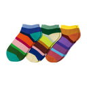 Set of three colorful striped socks on a white background