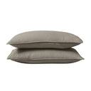 Two cool-toned beige pillows stacked on a white background