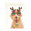 Dog with reindeer antlers and a bell on a greeting card