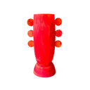 Neon pink and orange vase with spherical protrusions on a white background