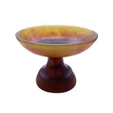 A brown resin pedestal bowl with organic swirls and gradient details