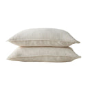 Two beige pillows stacked on a white background