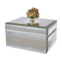 Decorative jewellery box with a textured surface and gold rock-like top piece on a white background