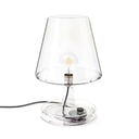 Clear glass table lamp with a visible bulb on a white background