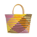 Colorful woven basket with a zigzag pattern on a white background