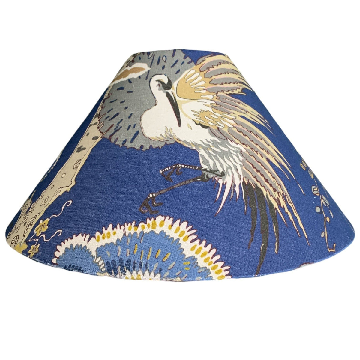 A dark blue fabric cone lampshade with white birds.