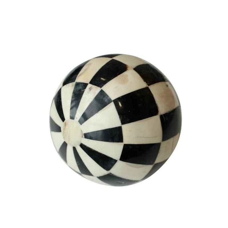 A decorative black and white checkered ball.