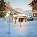 Multiple Bourgie lamps sitting in the snow.