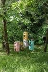 The Componibili drawer range by Kartell sitting on the grass with trees either side.