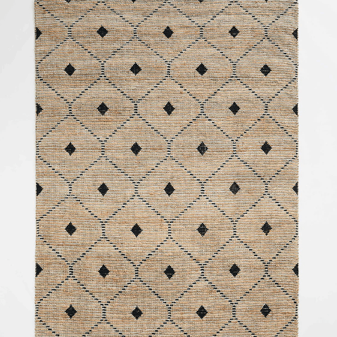 A natural coloured rug with a dark diamond pattern.